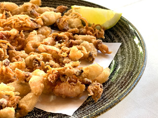 Fried and battered baby squid with lemon. A typical spanish tapa called chipirones fritos.