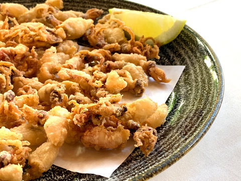 Fried and battered baby squid with lemon. A typical spanish tapa called chipirones fritos.