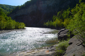 mountain river between sheer cliffs . blue clear water of the river.