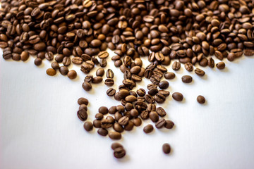Coffee beans isolated on white background. Mixture of different kinds of coffee beans. Fresh rosted coffee beans on white background, space for text. Close-up.