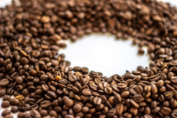 Coffee beans isolated on white background with place for text. Frame of coffee beans on white background. Closeup of coffee beans on plain paper.