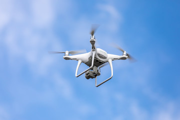Drone quadrocopter with high resolution digital camera on the sky background.