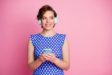 Close-up portrait of her she nice-looking attractive lovely charming cute cheerful cheery wavy-haired girl listening single rock hit spending free time isolated on pink pastel color background