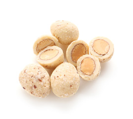 Tasty coated nuts on white background