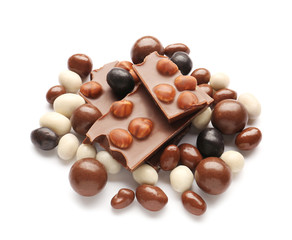 Tasty chocolate candies with nuts on white background
