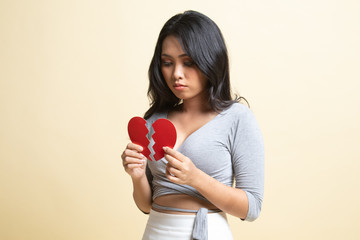 Beautiful young Asian woman with broken heart.