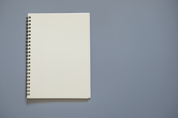 Top view of white school notebook on a gray background with copy space