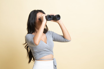 Young Asian woman with binoculars.