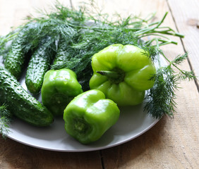 green peppers, cucumbers and herbs close-up