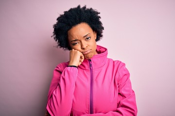 Fototapeta na wymiar Young African American afro sportswoman with curly hair wearing sportswear doin sport thinking looking tired and bored with depression problems with crossed arms.