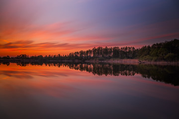 Long exposure sunset evening view on Sukhovilske Lake and forest in Sukhovolia, Rudno. Lviv district, Ukraine. May 2020