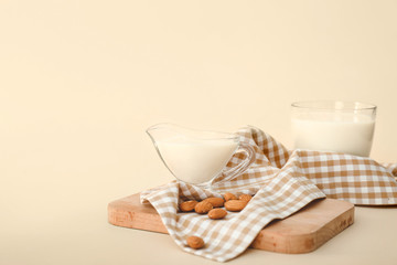 Tasty almond milk on color background