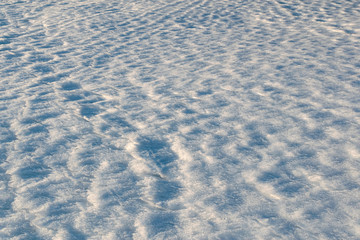 Footprints on the winter carpet , on the white snow, on the layer of frozen crystal coating