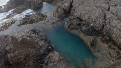 Obraz premium Walking along the coast contemplating the wonders of nature with its mountains,its natural pools and its ocean