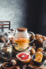 Hot tea with slices of fresh grapefruit on wooden tablet. Healthy drink, Eco, vegan