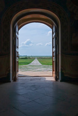 Open wooden door to the world with green environment. Climate change concept. Meditative stone walkway. 