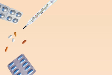 Pills for levitation. Pills and thermometer on a blue background that fall down. Pills, medicine and health. Virus protection concept. Flat lay, top view, copy space