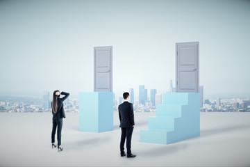 Businessman and businesswoman looking on ladder with closed door