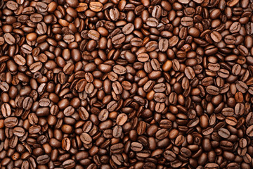 Top view of brown roasted coffee beans, can be use as background, copy space for text.