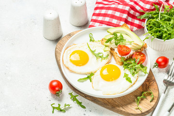 Healthy breakfast with egg, toast and salad.
