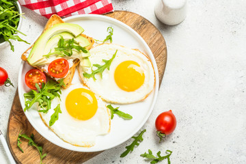 Healthy breakfast with egg, toast and salad.