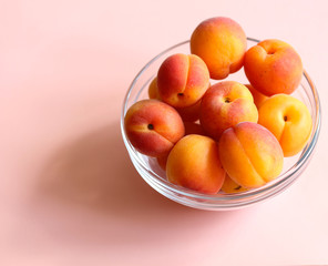 ripe apricots in a glass bowl close up