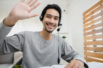 Portrait photo of smart Asian guy using video call communicate with business colleague friend from...