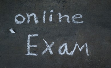 Fototapeta premium Online Exam Written with White Chalk on Black Surface