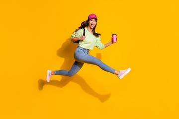Full body profile photo of energetic lady student hold backpack takeout coffee jump high rushing...