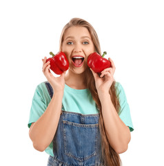 Young woman with bell peppers on white background. Diet concept