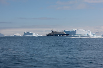 Antarctica landscape with sea and icebergs on a cloudy winter day