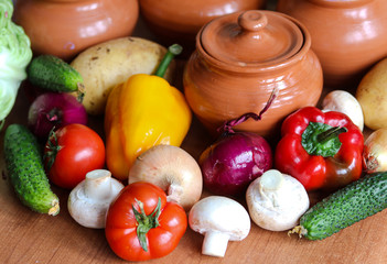 fresh vegetables and clay pots on the table close up