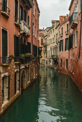 Fototapeta na wymiar Venetian canal and old facades of houses.