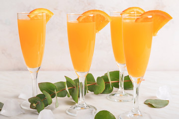 Glasses of tasty mimosa cocktail on table