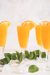 Glasses of tasty mimosa cocktail on table