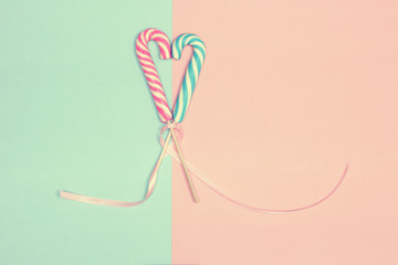 Heart shaped candy canes. Vintage pastel colored minimal concept
