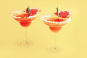 Glasses of tasty mimosa cocktail on color background