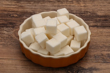 Refined white sugar cubs in the bowl