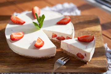 slice of strawberry cheesecake on white background, selective focus, square image