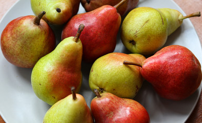 ripe pears on a white plate close up