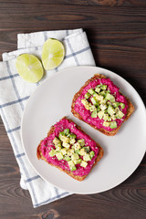 Avocado toasts with beetroot hummus and whole grain rye bread