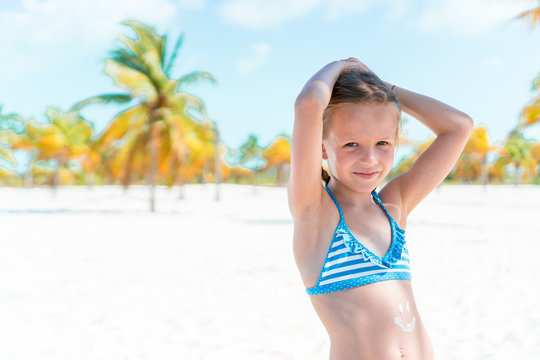 Cute little girl at beach during caribbean vacation