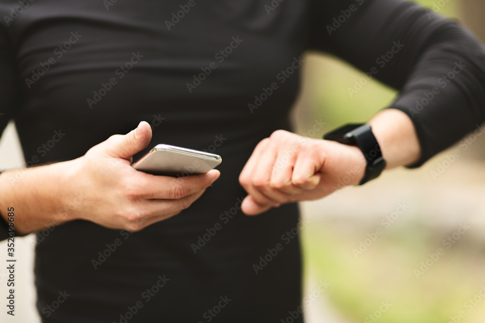Aufkleber man checking activity tracker on wrist watch
