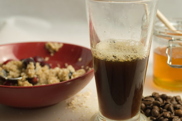 Fresh coffee with healthy breakfast of porridge, honey and medium shot