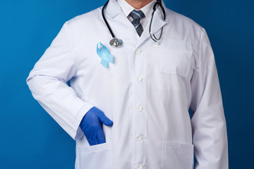 blue silk ribbon attached to a white coat of a medic