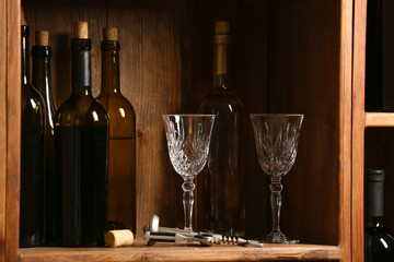 Bottles of wine and glasses in cellar
