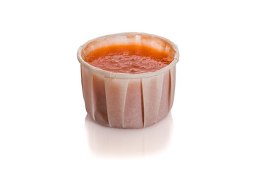 Red tomato Sauce in recyclable paper cup isolated on white background.