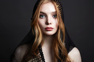Beautiful young Woman in Hood. Red Hair Girl