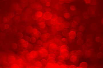 Red glitter vintage lights background. Red bokeh on black background.