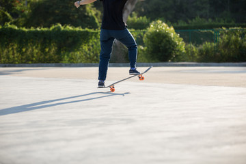 Fototapeta na wymiar Skateboarder skateboarding at sunrise park